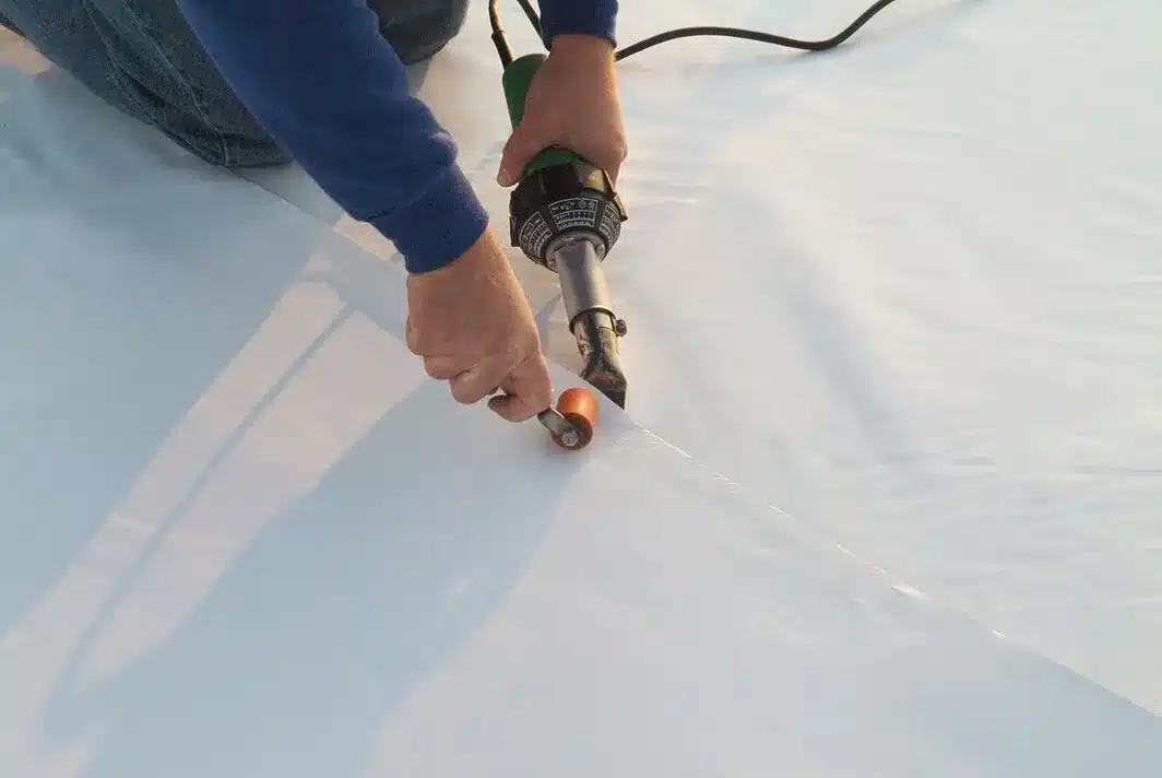 Licensed and insured commercial roofer working on a roof in Meadville, PA.