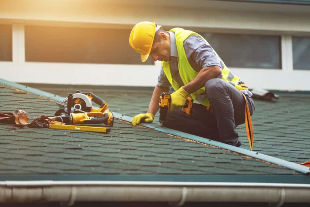 Roofer working in protective gear and gloves in Meadville, PA.