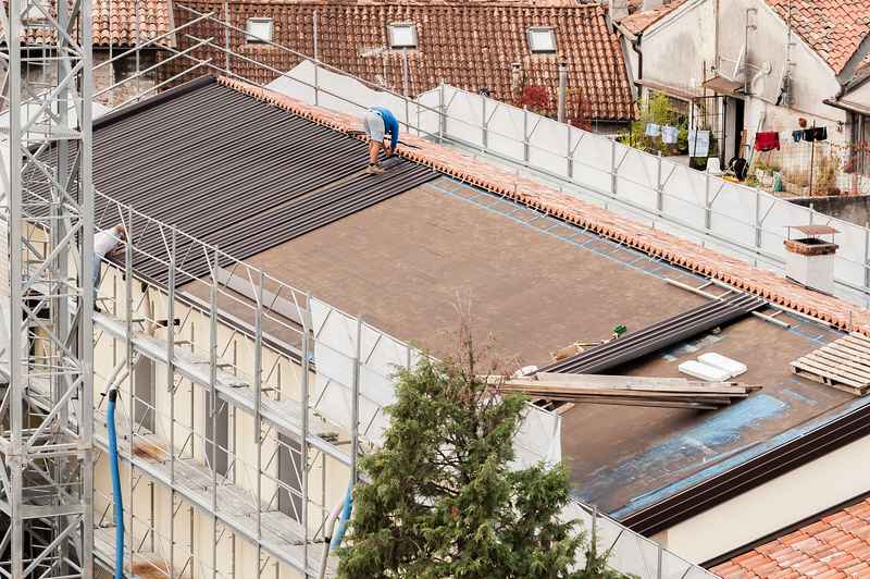 Drone view of workers constructing a roof in Meadville, PA.